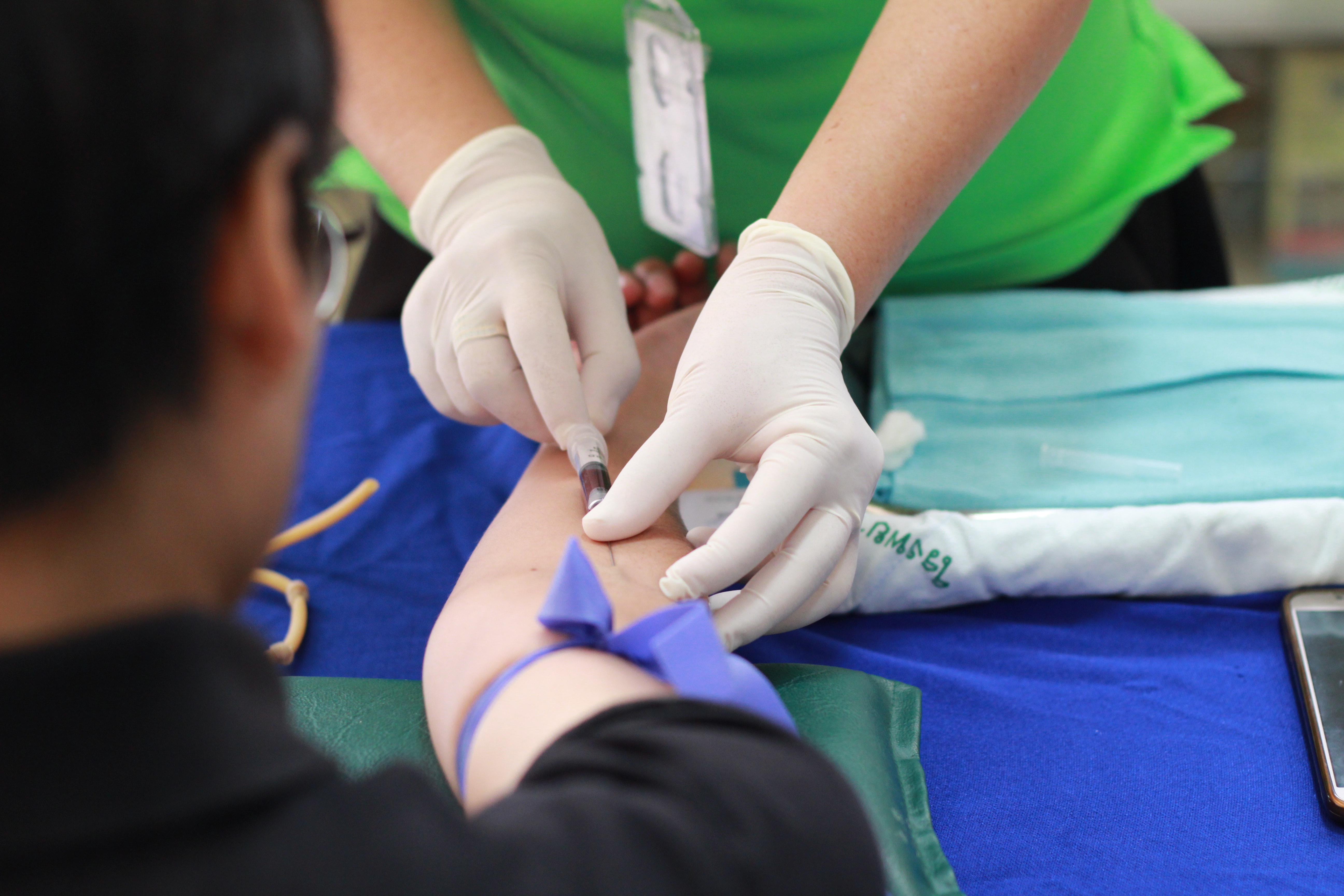 Using rubber gloves when performing blood work