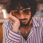 A tired man wearing sunglasses