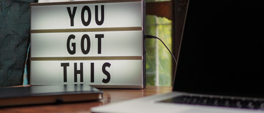 Sign saying "You Got This" next to a computer