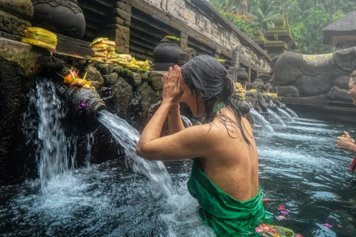 Woman with faith praying in healing water