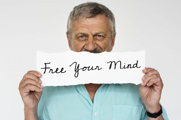 Man holding a sign saying Free Your Mind