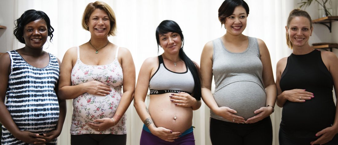 Multiple pregnant women posing