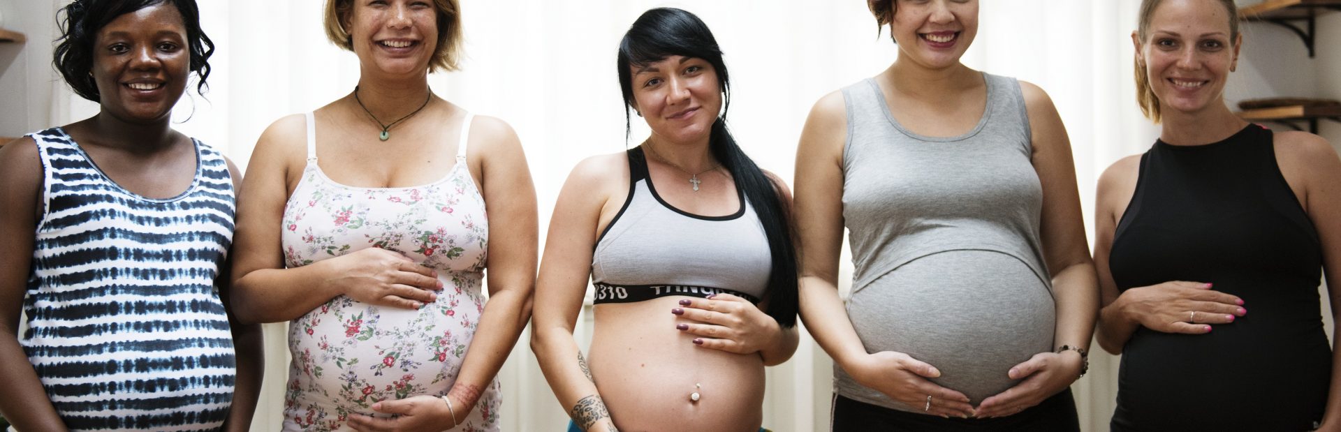 Multiple pregnant women posing