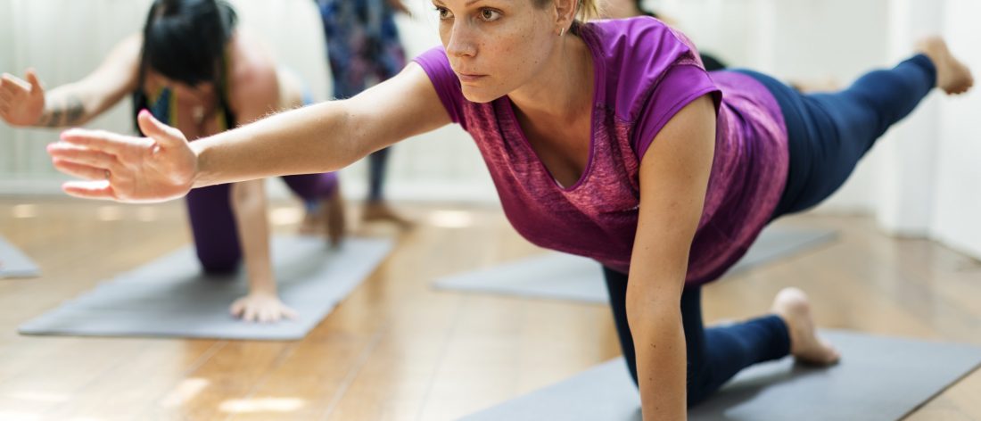 Woman performing a pose at a Yoga class