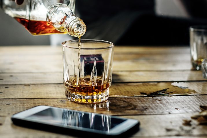 Someone pouring a scotch - a drink too many