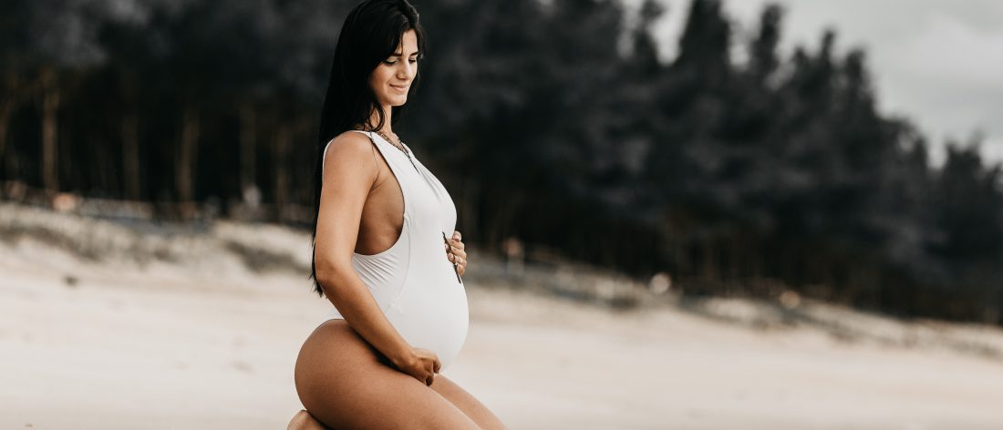 Pregnant woman getting ready to swim