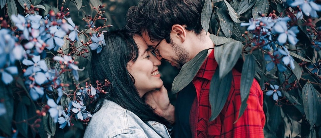 Loving couple standing under a tree