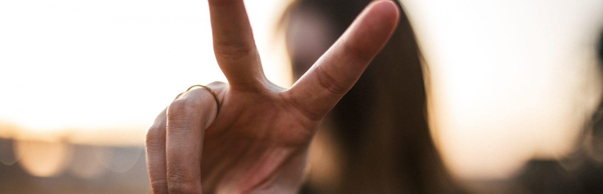 A woman making the peace sign