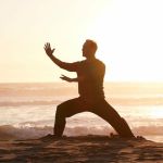 Man on beach practicing Qigong