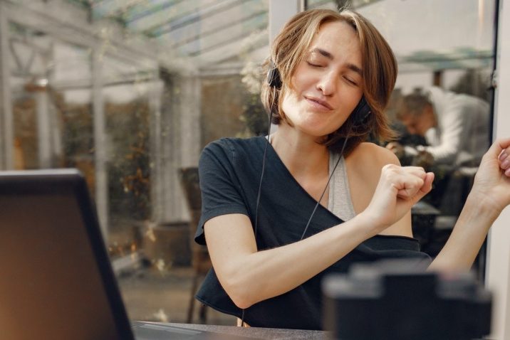 Woman closing eyes at her computer